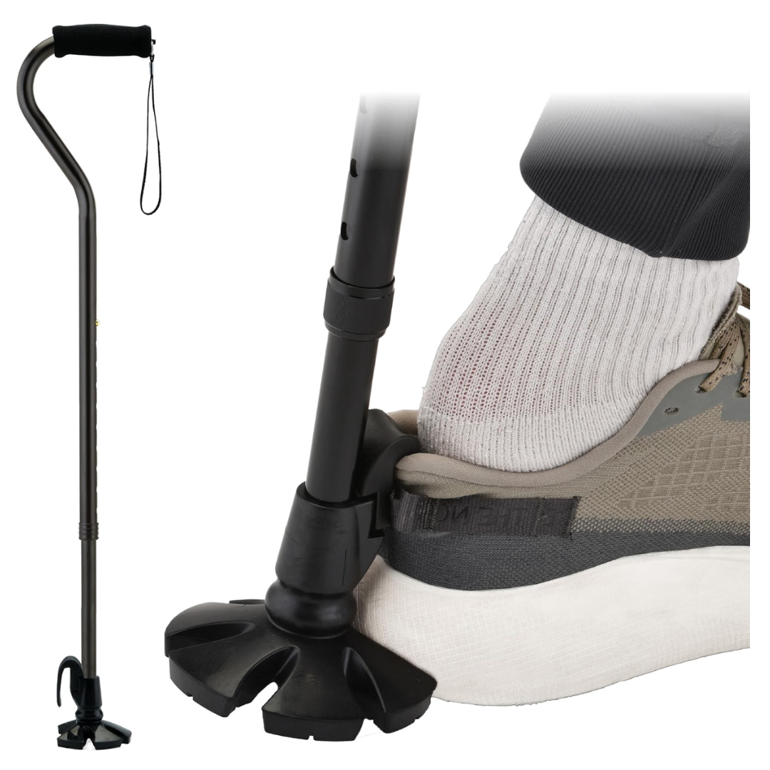 The Nova Walking Cane with Shoe Horn | 2-in-1 Shoe Helper & Walking Aid is a black cane with a quad base that not only assists with walking, but also helps remove a sneaker by pressing down on the heel like a shoe horn, allowing a sock-covered foot to slip out easily.